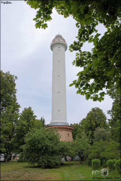 Mi?e??b??ka (Mikeltornis) lighthouse
This is the tallest lighthouse in Latvia, or indeed in any of the three Baltic republics. The original lighthouse was patched up after being damaged in World War I, but it had to be demolished in 1932. Its replacement was destroyed during World War II and replaced in 1946 by a temporary wood tower. Located just off the coastal P124 highway about 12 km (7.5 mi) west of Lielirbe. Site open; tower open somedays.
---
Legends tell that the name ???Mikelbaka??? dates back to 1749, when the dangerous shoal of the local coast was surveyed by Mikhail Ryabinin, the midshipman of the Russian Navy. As time passed, the name was changed to a Latvian word ???Mikelis???, and now represents the tallest (56 meters) lighthouse tower in the Baltic States, located opposite the mentioned shoal. The lighthouse was misconstructed in 1884 when it started to lean from the vertical axis by 12 centimetres and crack because of the heavy weight and marshy ground; therefore, it was exploded in 1932. The next tower was demolished by the storms of World War II in 1941. The present-day Mi?e??b??ka lighthouse was built in 1957 as indicated in the sign above its front door. Two hundred and ninety three steps lead to the top of the lighthouse, rewarding each conqueror with a view overlooking the surrounding Kurzeme coast of the Baltic Sea and a lighthouse on the Syrve peninsula of Saaremaa, which can be seen in fine weather at a distance of 35 km.
Keywords: Latvia;Kurzeme;Gulf of Riga